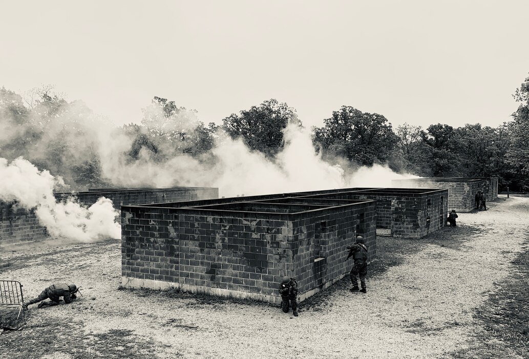 Students conduct a raid on an urban village during the culminating Field Training Exercise of the Military Police Basic Course. Smoke is deployed tactically to obscure the movement of Marines as they maneuver through their objective.