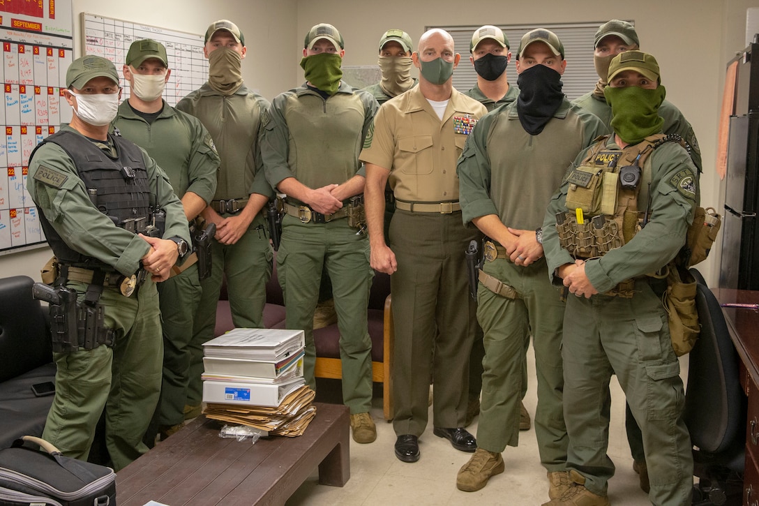 The 19th Sergeant Major of the Marine Corps, Sgt. Maj. Troy E. Black, poses for a photo with the special reaction team, part of the Provost Marshal Office (PMO) at Marine Corps Base Quantico, V.A., Sept. 9, 2020. The visit gave Sgt. Maj. Black the opportunity to recognize Marines for outstanding performance. On a continual basis, The mission of PMO is to protect the lives, rights, and property of all personnel and organizations aboard the installation. (U.S. Marine Corps photo by Sgt. Victoria Ross)