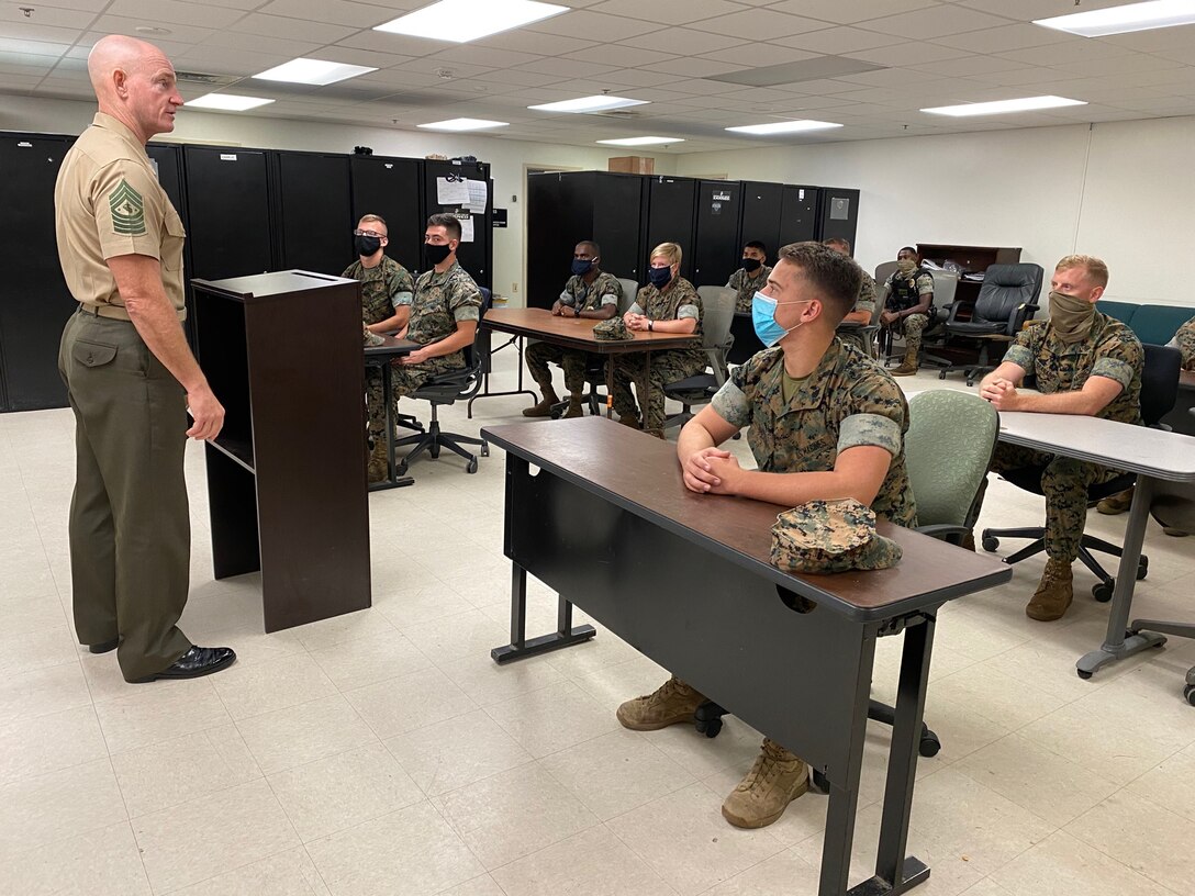 U.S. Marine Corps Sgt. Maj. Troy E. Black, Sergeant Major of the Marine Corps, talks with Marines at Marine Corps Base Quantico Provost Marshal Office (PMO), Quantico, V.A., Sept. 9, 2020. On a continual basis, PMO protects the lives, rights, and property of all personnel and organizations aboard the installation in order to support unit and personnel readiness and create and preserve an atmosphere of safety and security.(U.S. Marine Corps photo by Sgt. Victoria Ross)