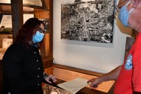 Norfolk Naval Shipyard (NNSY) Executive Development Program (EDP) Cadre 9 team member General Arrangements Branch (Code 254) Naval Architect Rachel Yarasavich joined NNSY Historian Marcus Robbins in curating the latest exhibit on World War II in the Heritage Room.