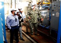 Norfolk Naval Shipyard (NNSY) Executive Development Program (EDP) Cadre 9 team members General Arrangements Branch (Code 254) Naval Architect Rachel Yarasavich, Code 105.2 Radiological Engineer Sasha Norfleet, and Code 361 Nuclear Zone Manager Aaron Jarman toured the production shops with Code 300 Operations Officers Capt. Michael Oberdorf to see the equipment readily available at America's Shipyard.
200803-N-SY521-366: Norfolk Naval Shipyard