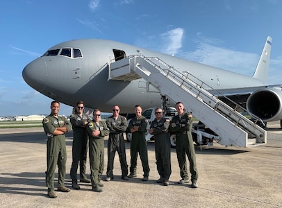 From left, Capt. Erik Earle, Capt. Chris Schimmel, Maj. Matt Valentino, Master Sgt. Brett Peterson, Capt. Jordan Gauvin, Chief Master Sgt. Michael George and Maj. Leon Rice pose in front of a KC-46A Pegasus on Sept. 8, 2020, at Kadena Air Base, Japan. The Pease Airmen executed the first official transoceanic coronet ever accomplished with a Pegaus refueler, which began Sept. 9 and involved 16 aerial refuelings of five F/A-18 jets.