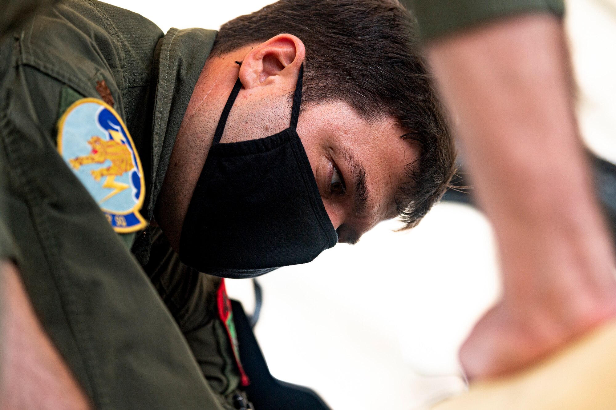 A photo of an Airman showing the 23d Wing commander an ejection seat