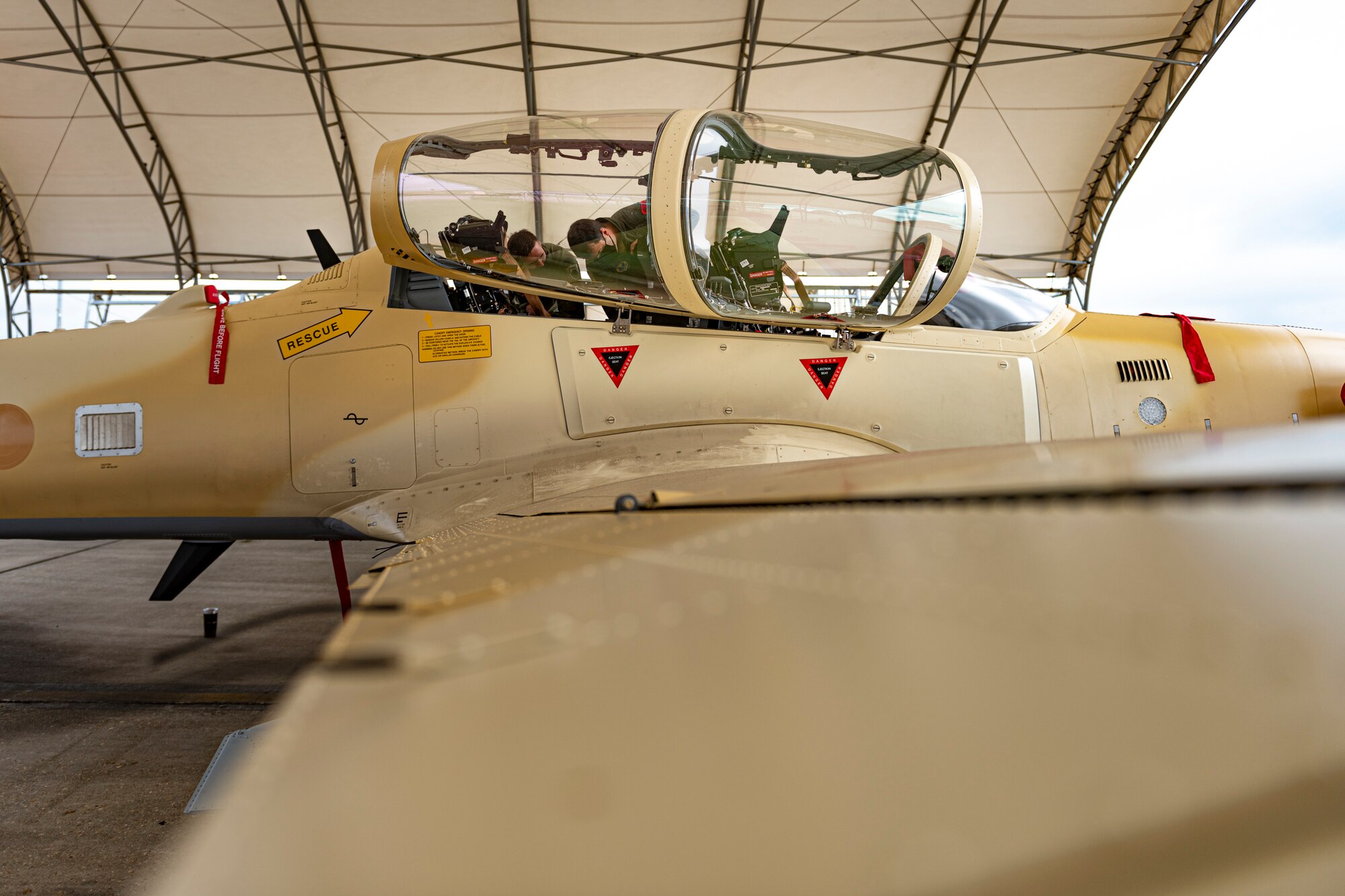 A photo of an Airman demonstrating egress procedures