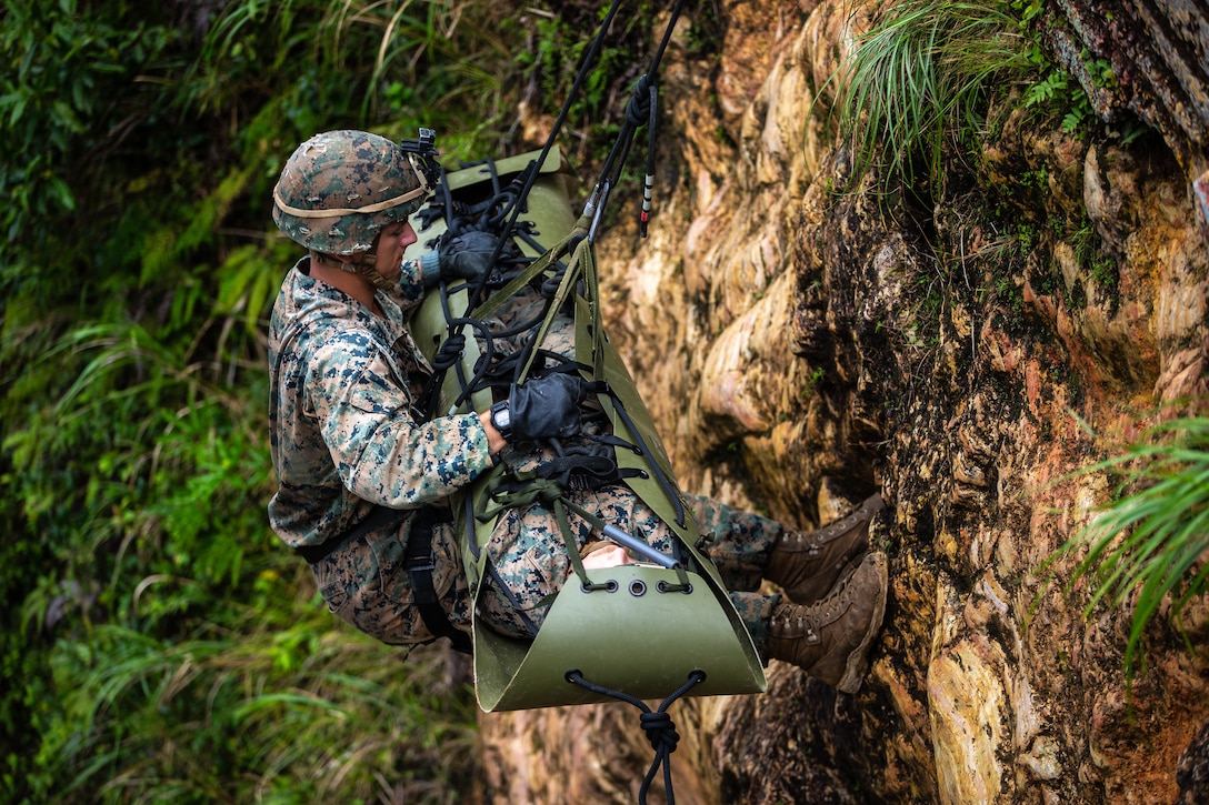 U.S. Marines participate in a simulated casualty evacuation via rappelling drills of the Infantry Jungle Skills Course at the Jungle Warfare Training Center on Camp Gonsalves, Okinawa, Japan, Sept. 10.