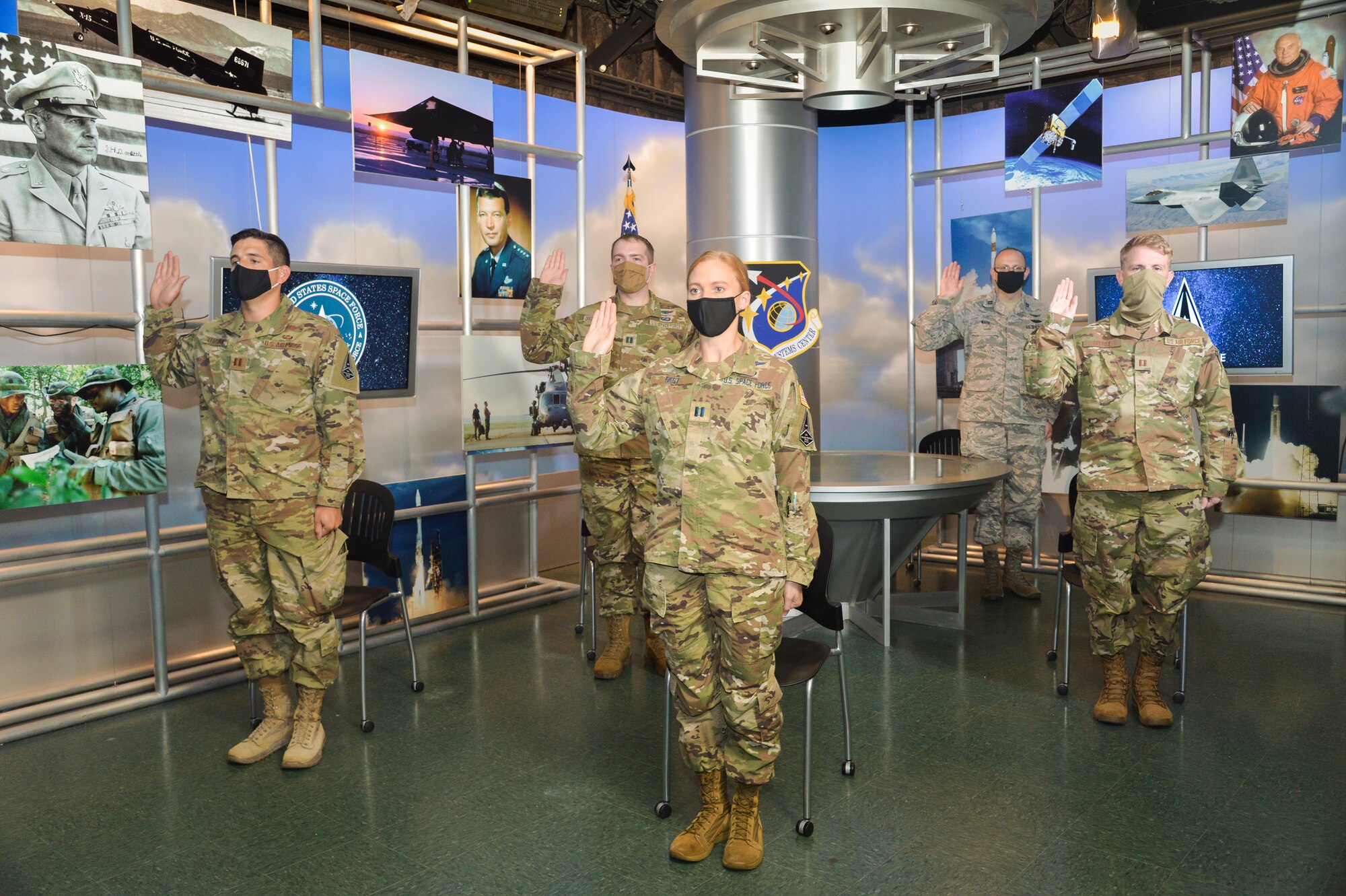 Five members from the Space and Missile Systems Center at Los Angeles Air Force Base, California, participate in a ceremonial swearing-in event broadcasted from the Air Force Association’s 2020 Virtual Air, Space and Cyber Conference and administered by Gen. John “Jay” Raymond, United States Space Force Chief of Space Operations, Sept. 15, 2020. Beginning on Sept. 1, more than 2,400 active-duty Airmen in space operations (13S) and space systems operations (1C6) career fields will transfer to the USSF. (U.S. Space Force photo by Van Ha)