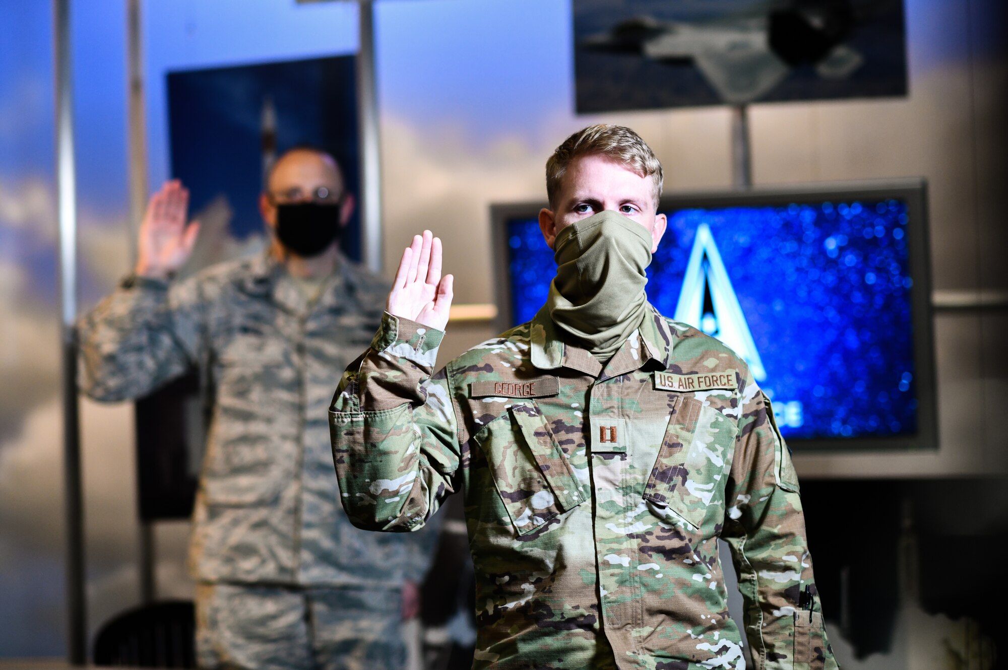 U.S. Air Force Capt. Brandon George, Space and Missile Systems Center project officer at Los Angeles Air Force Base, California, participates in a ceremonial swearing-in event broadcasted from the Air Force Association’s 2020 Virtual Air, Space and Cyber Conference and administered by Gen. John “Jay” Raymond, United States Space Force Chief of Space Operations, at Los Angeles Air Force Base, California, Sept. 15, 2020. To officially transfer from one military service to another, a military member separates from the current service and commissions or enlists into the new service in their current rank. (U.S. Space Force photo by Van Ha)