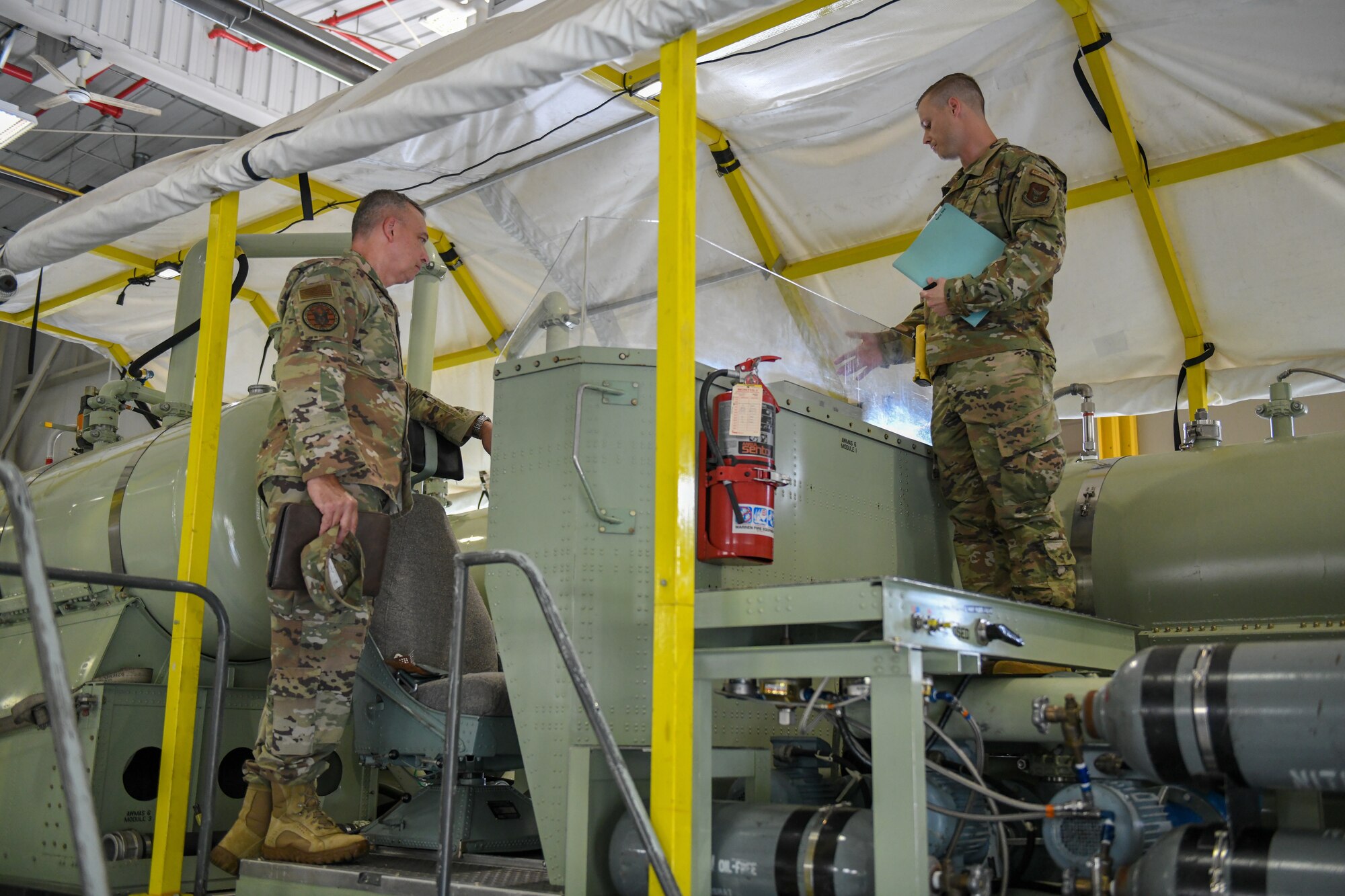 Brig. Gen. William Kountz, the director of logistics,engineering and force protection for Air Force Reserve Command, watches as Tech. Sgt. Chadwick Conroy, aerospace maintenance craftsman assigned to the 910th Maintenance Squadron, displays the 910th Airlift Wing’s modular aerial spray systems, Sept. 13, 2020, at Youngstown Air Reserve Station, Ohio.