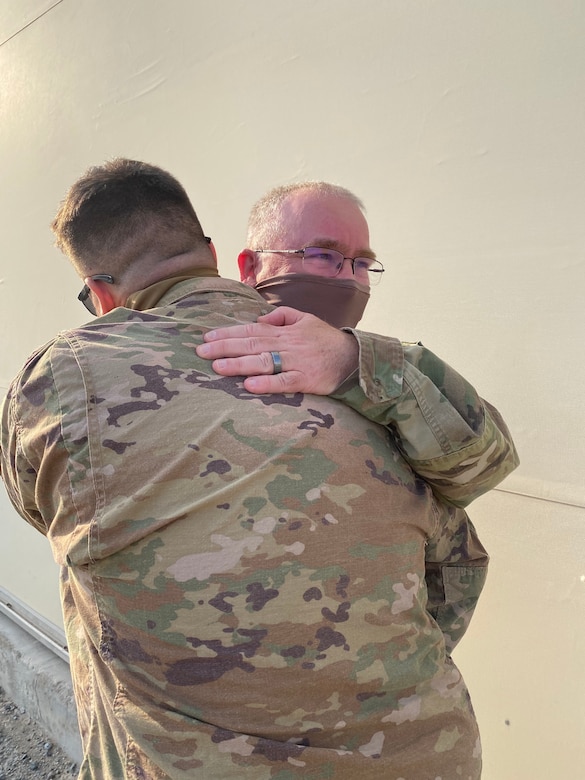 1st Sgt. Richard Lane, an aircraft maintenance senior sergeant with 1st Battalion, 137th Aviation Regiment, embraces his son Spc. Michael Lane after reuniting in theater.  Spc. Lane has been on deployment with 1st Battalion, 145th Armor Regiment for the past year.