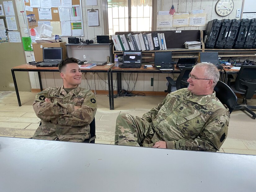 Spc. Michael Lane (left) and his father 1st Sgt. Richard Lane (right) of Antrim, Ohio catch up after spending a year apart.  Spc. Lane will be returning home after a successful mission with 1st Battalion, 145th Armor Regiment, while 1st Sgt. Lane begins his fifth and final tour with 1st Battalion, 137th Aviation Regiment.