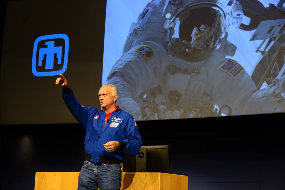 John Olivias, an American engineer and a former NASA astronaut, gives a presentation in the Steve Schiff Auditorium of Sandia National Laboratories on Sept. 25, 2019.