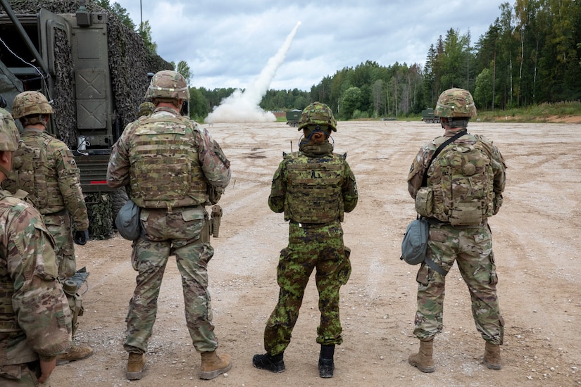 Soldiers assigned to Bravo Battery, 1st Battalion, 6th Field Artillery Regiment and soldiers from the Estonian Defence Force watch as a rocket takes flight in the distance during live fire exercise with Estonian Defense Force in Tapa, Estonia Sept. 5, 2020.