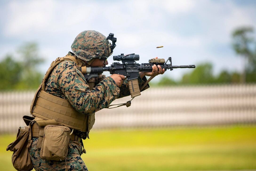 A Marine fires a rifle at a target.