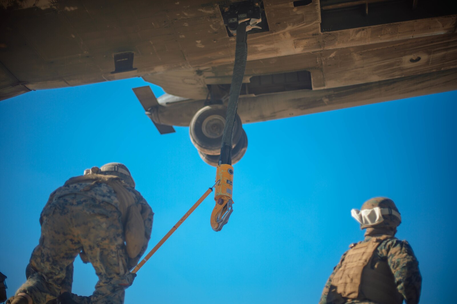 U.S. Marine Corps Sgt. Blake Charres, a loading support specialist with 1st Transportation Support Battalion, 1st Marine Logistics Group, attaches a static hook to a CH-53E Super Stallion from Marine Heavy Helicopter Squadron 465, 3rd Marine Aircraft Wing, during a helicopter support team training exercise as it prepares to lift a Humvee in Yuma, Ariz., on Jan. 23, 2019.