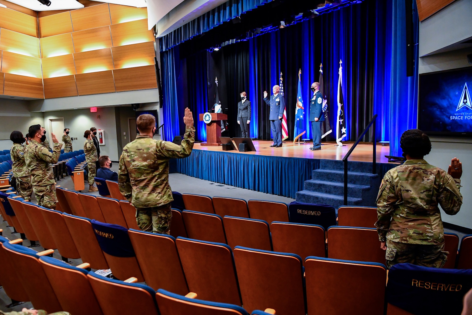 Chief of Space Operations Gen. John W. Raymond, center rear, administers the oath of office to airmen transferring into the U.S. Space Force during a ceremony at the Pentagon, Arlington, Va., Sept. 15, 2020. About 300 airmen at bases worldwide, including 22 in the audience, transferred during the ceremony.  (U.S. Air Force photo by Eric R. Dietrich)
