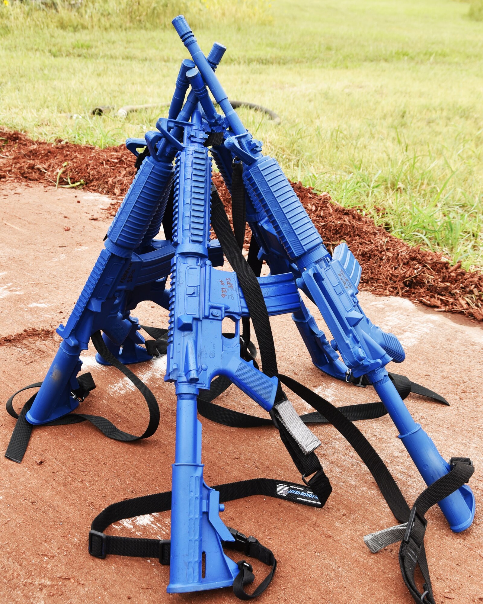 A collection of M4 assault rifle replicas arranged by Airmen of the 931st Civil Engineer Squadron, sits nearby during a 931st Air Refueling Wing operational exercise Sept. 11, 2020, at McConnell Air Force Base, Kansas.  The rubber ducks are in the shape of an M4 rifle, and are issued during operational readiness exercises to add realism to the training.
