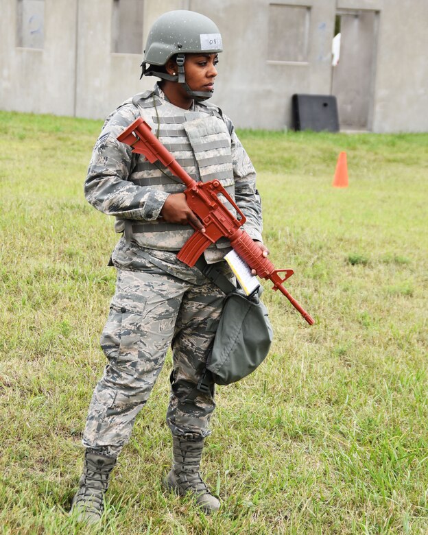 Senior Airman Kimnece Redae, 931st Security Forces patrolman, holds a red M4 assault rifle replica  as she scans the site of a simulated improvised explosive device, during a 931st Air Refueling Wing operational readiness exercise Sept. 11, 2010, at McConnell Air Force Base, Kansas. The three-day readiness exercise provides Airmen with the training they need in order to carry out mission requirements with efficiency and accuracy.