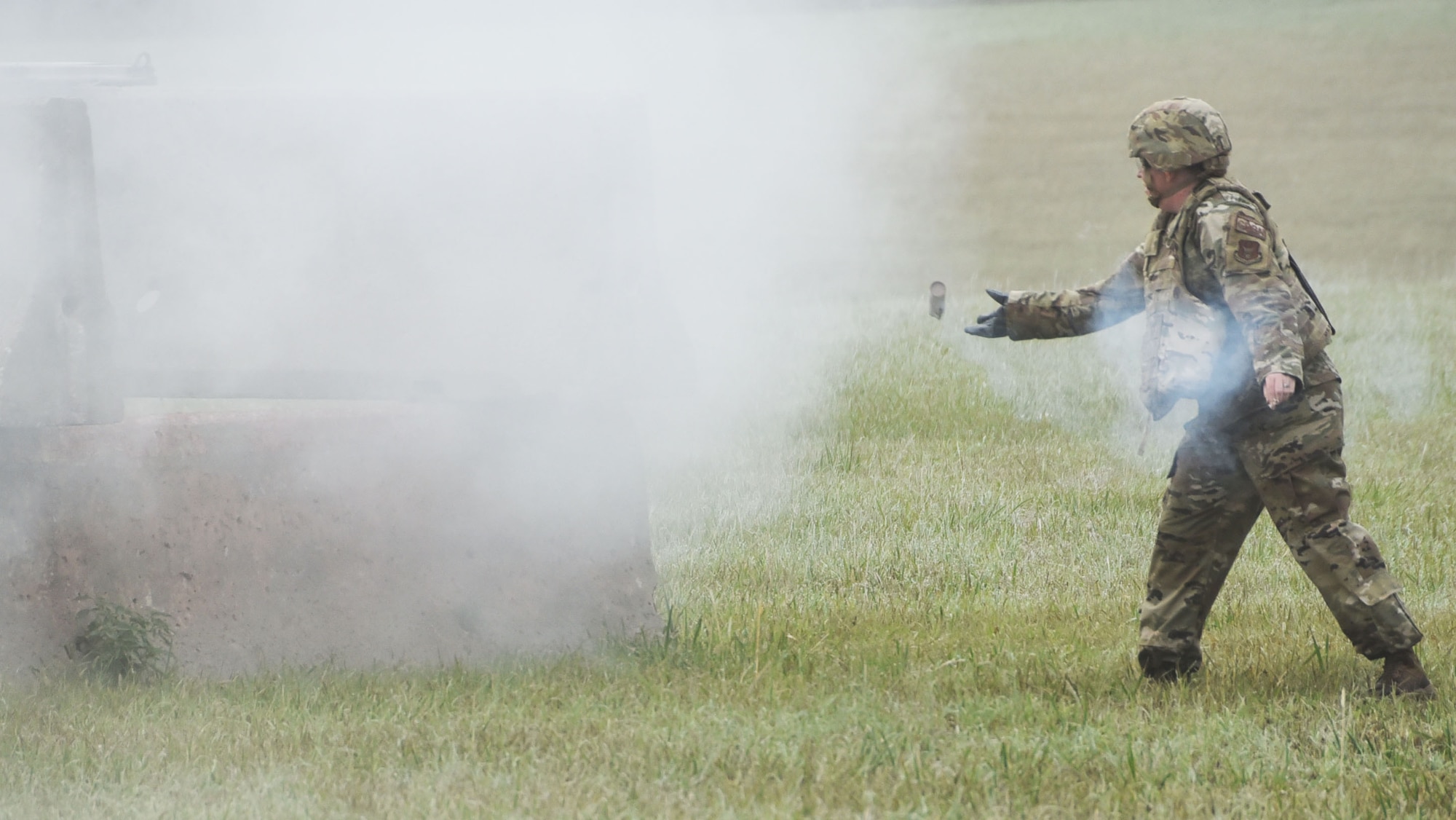 Master Sgt. Stacey Botzet, 931st Civil Engineer Squadron program manager, throws a ground burst simulator as part of a three-day 931st Air Refueling Wing operational readiness exercise Sept. 12, 2020, at McConnell Air Force Base, Kan.  The GBS’s were to simulate smoke after an attack, to evaluate 931st ARW’s Airmen’s ability to respond after an explosives attack.
