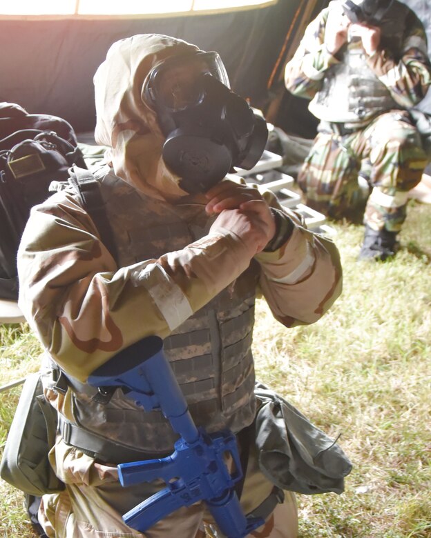 An Airman from the 931st Security Forces Squadron dons Mission Oriented Protective Posture Gear during a simulated chemical attack Sept. 12, 2020, at McConnell Air Force Base, Kans.  The event was part of three-day 931st Air Refueling Wing Operational Readiness exercise that evaluated Airmen’s ability to carry out mission requirements and respond after a chemical attack.