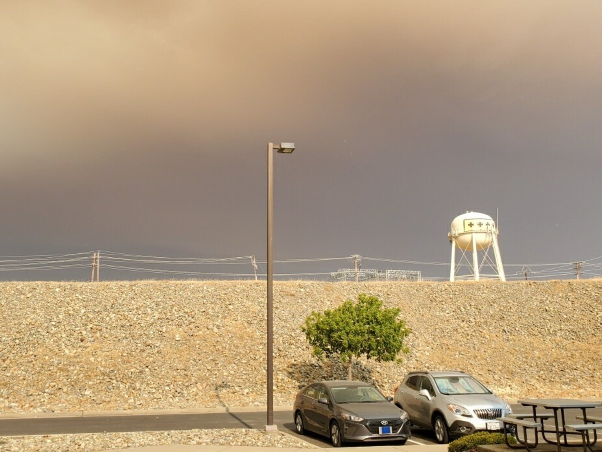 The smoke creates a contrast of color over Beale AFB. The view of the water tower shows a stark comparison to how thick the ash and smoke have become during this fire season.