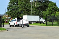 A convoy carrying equipment for a deployable command post departs Joint Task Force Civil Support (JTF-CS) during Vibrant Response 20 Lite.