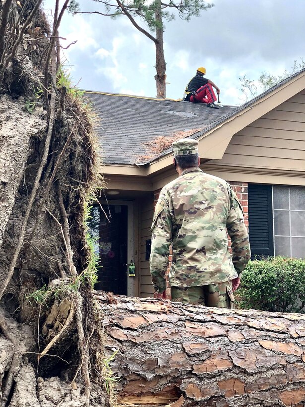 IN THE PHOTO, Memphis District Commander and Hurricane Laura Relief Operations Commander Col. Zachary Miller watches as a U.S. Army Corps of Engineers contractor works on installing a temporary 'blue roof' for a homeowner who applied for the free assistance program. The purpose of the Blue Roof Program is to provide homeowners in disaster areas with fiber-reinforced sheeting to cover damaged roofs until permanent repairs can be made. The deadline to sign up for this free assistance is Sept. 30, 2020. (USACE photo by Lt. Col. Nathan Molica)