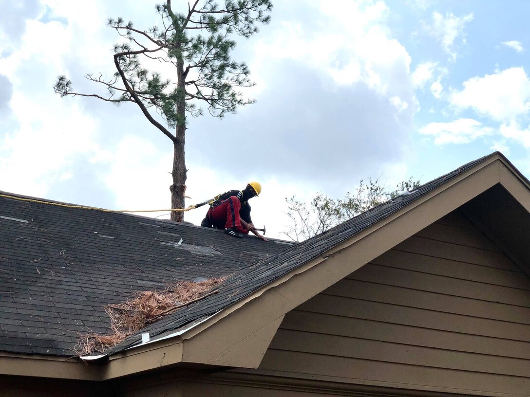 IN THE PHOTO, a U.S. Army Corps of Engineers contractors works on installing a temporary 'blue roof' for a homeowner who applied for the free assistance program. The purpose of the Blue Roof Program is to provide homeowners in disaster areas with fiber-reinforced sheeting to cover damaged roofs until permanent repairs can be made. The deadline to sign up for this free assistance is Sept. 30, 2020. (USACE photo by Lt. Col. Nathan Molica)