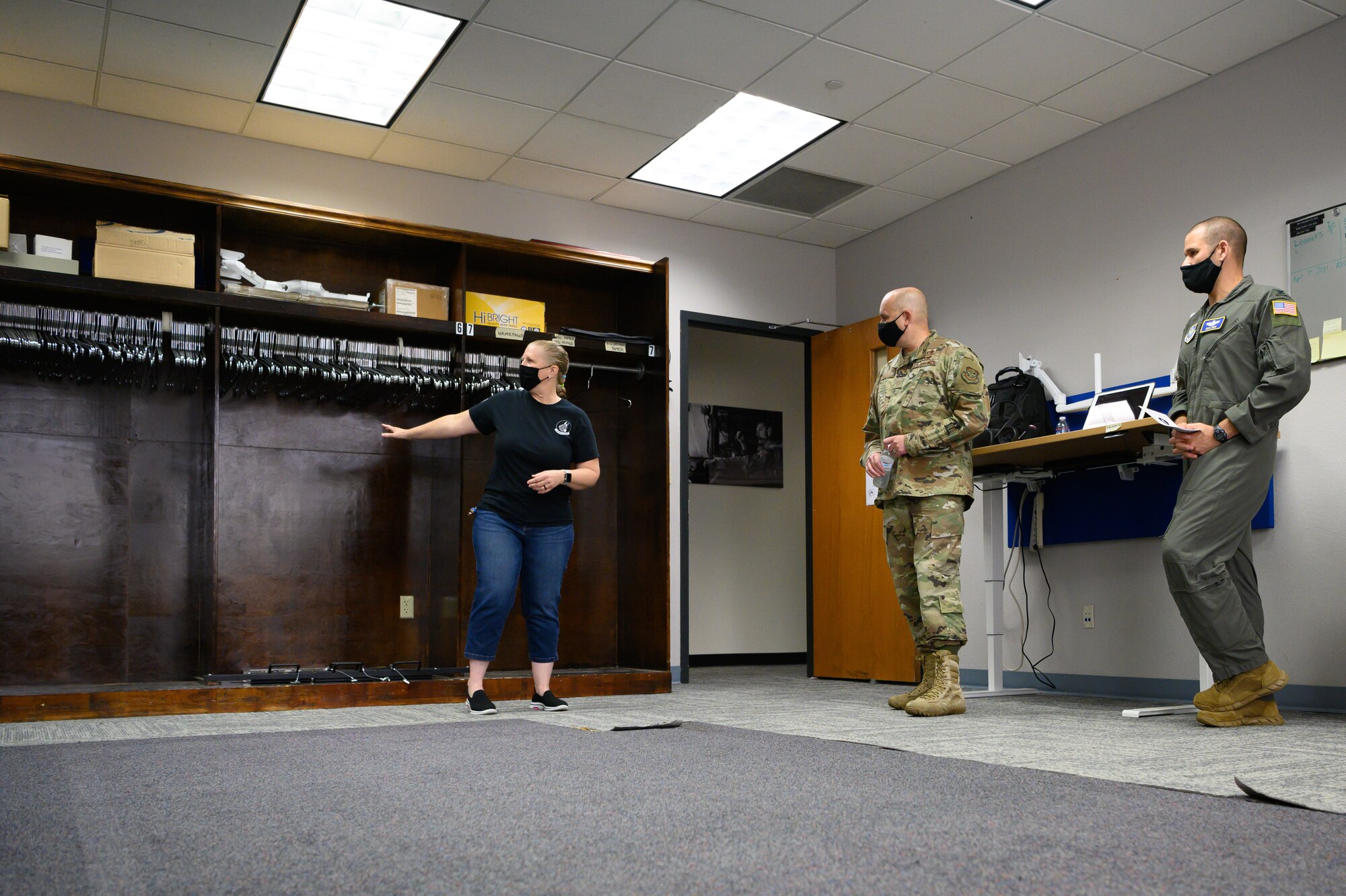Training manager shows old supply room to leadership.