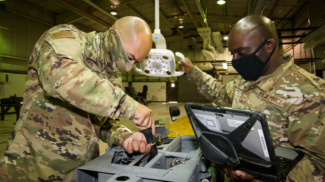 Aircrew egress specialist Senior Airman Alberto Rory, 482nd Fighter Wing, Homestead Air Force Base, Florida, and Senior Airman Bethenokelm Volcy, conduct maintenance on an ejection seat at Edwards Air Force Base, California, July 24. (Air Force photo by Giancarlo Casem)