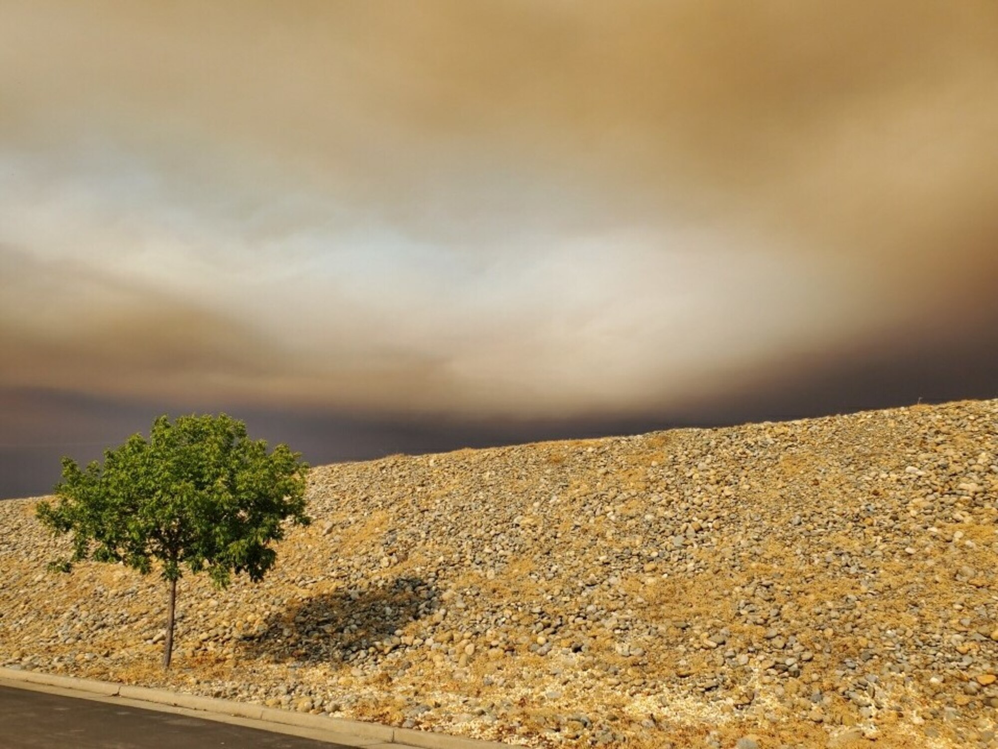 Smoke fills the atmosphere as it moves in a southerly direction to cover the air space above the Air Force installation.