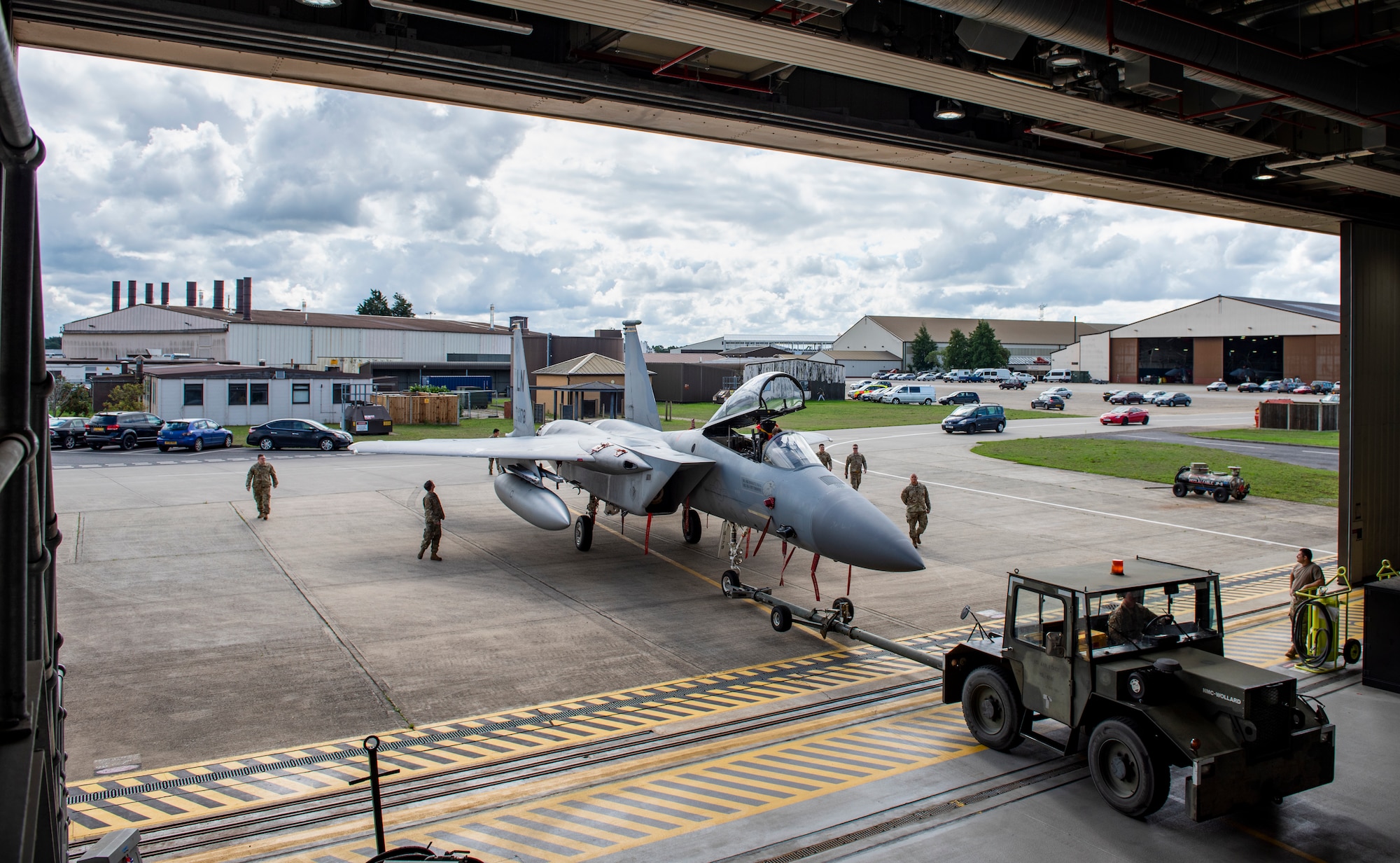 U.S. Air Force Airmen, assigned to the 48th Component Maintenance Squadron fuels systems maintenance shop, tow an F-15C Eagle into the hangar during an Agile Combat Employment training at Royal Air Force Lakenheath, England, Aug. 31, 2020. Proficiency in a multitude of skills allows Airmen to more effectively and efficiently respond to unique scenarios and potential threats, which is a key aspect of the ACE initiative. (U.S. Air Force photo by Airman 1st Class Jessi Monte)