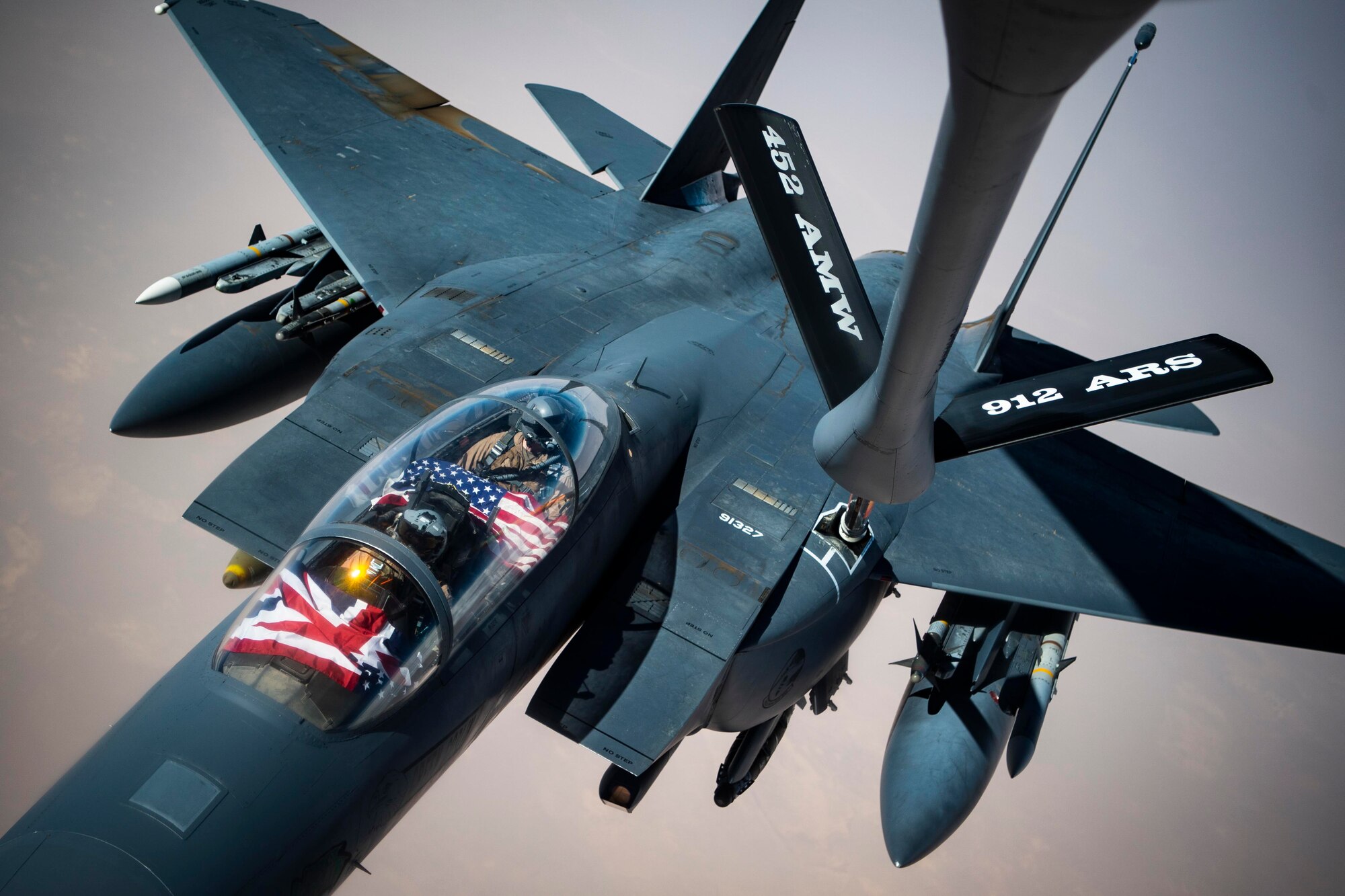 An aircraft receives fuel from another aircraft in midair.