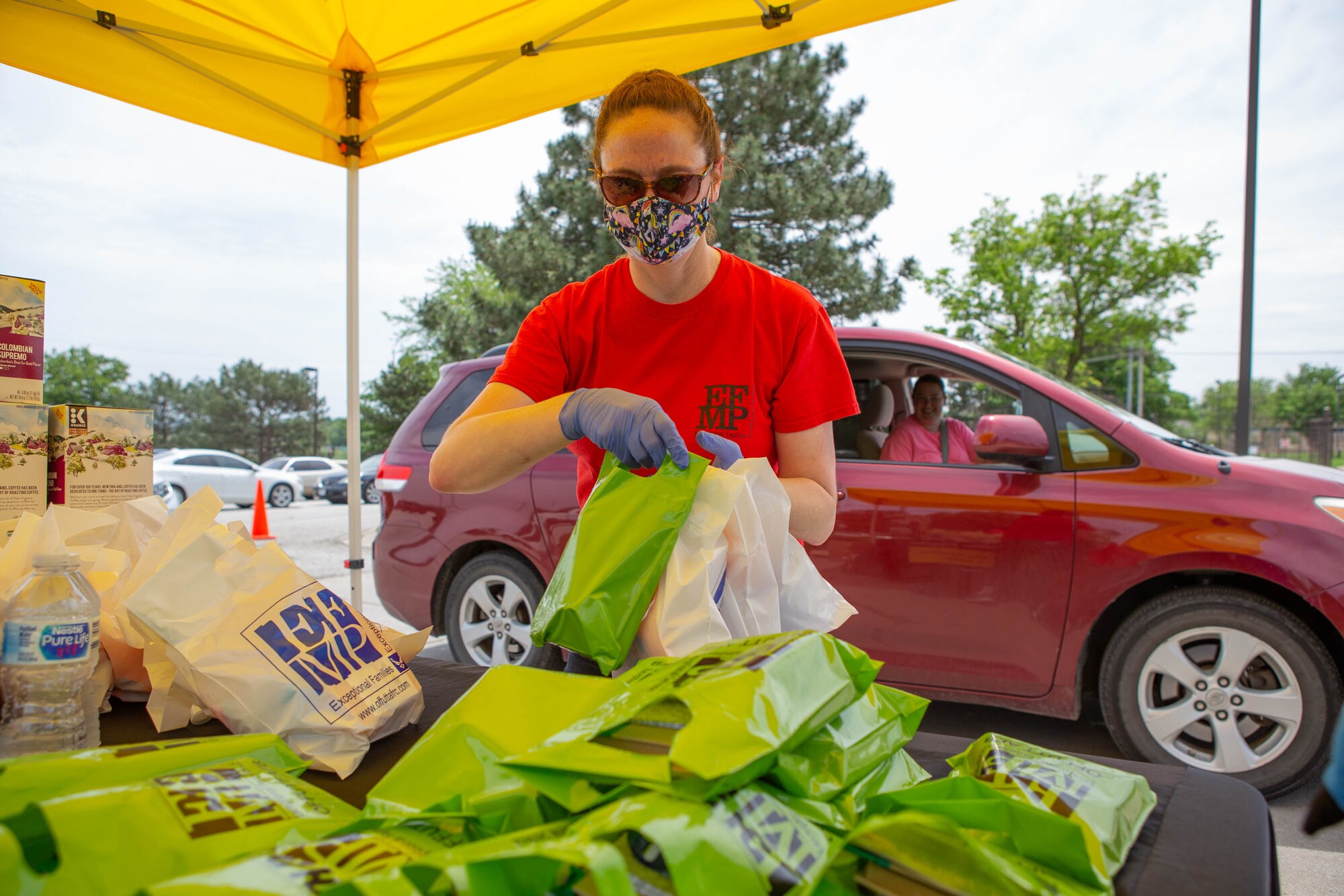 Woman gathers gift bags for EFMP families