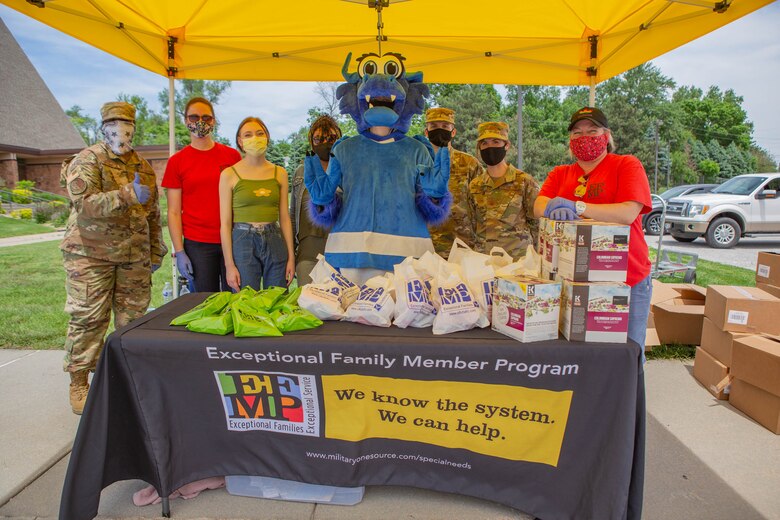 EFMP family support team poses for a photo at their gift booth.