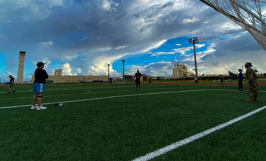 A photo of members of the Air Force Reserve's 44th Aerial Port Squadron performing self-paced sit-ups as part of the 624th Regional Support Group's Resiliency Tactical Pause session at Andersen Air Force Base, Guam, Sept. 13, 2020.