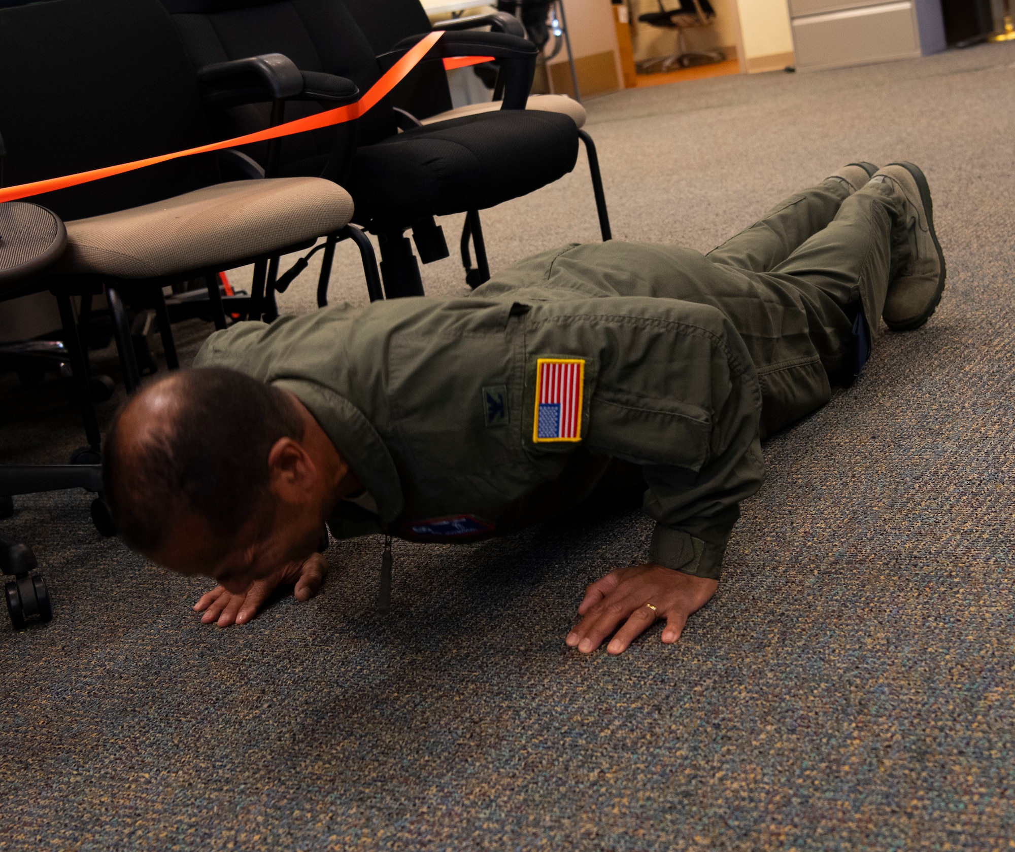 A photo of U.S. Air Force Col. Edward Johnson, 624th Aeromedical Staging Squadron commander, doing push-ups as part of a Resiliency Tactical Pause at Joint Base Pearl Harbor-Hickam, Hawaii, Sept. 12, 2020, during the 624th Regional Support Group Unit Training Assembly.