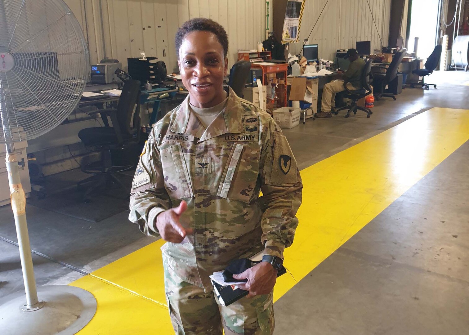 Army Col. Fredericka Harris, new commander 406th Army Field Support Brigade, offers her gratitude for their support as she addresses Defense Logistics Agency employees on the importance of collaboration between DLA Disposition Services and her unit.