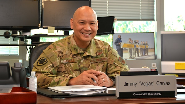 Air Force Brig. Gen. Jimmy Canlas sitting at his desk