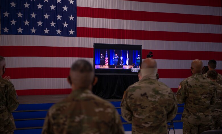 Photo of Airmen facing a television before taking their oath virtually