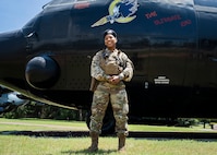 Photo of Airman standing in front of an AC-130