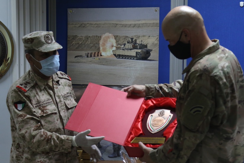 Brig. Gen. Thomas Spencer the 42nd Infantry Division Deputy Commander for Support is presented with a gift from Kuwait military Brig. Gen. Khaled Al-Shualah on September 10, 2020 in Kuwait. The Two country have been working together to strengthen their partnership. (U.S. Army Photo by Sgt. Andrew Winchell)