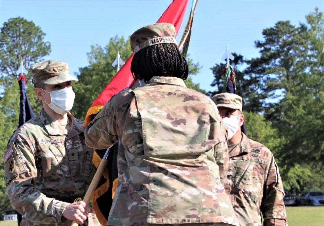 Col. Janene Marshall-Gatling, outgoing 4th Brigade (Personnel Services) commander (right), passes the 4th Brigade (PS) unit guidon to Brig. Gen. Stephen Iacovelli (left), 94th Training Division-Force Sustainment commanding general, as she relinquished command of the brigade during the unit’s change of command ceremony held on Victory Field at Fort Jackson, S.C., July 11, 2020. Marshall-Gatling served as the 4th Brigade (PS) commander for two years before relinquishing command to Col. Aaron Wilkes. (U.S. Army Reserve photo courtesy of 1st Lt. Matthew Rutledge, 4th Brigade (PS), 94th TD-FS)