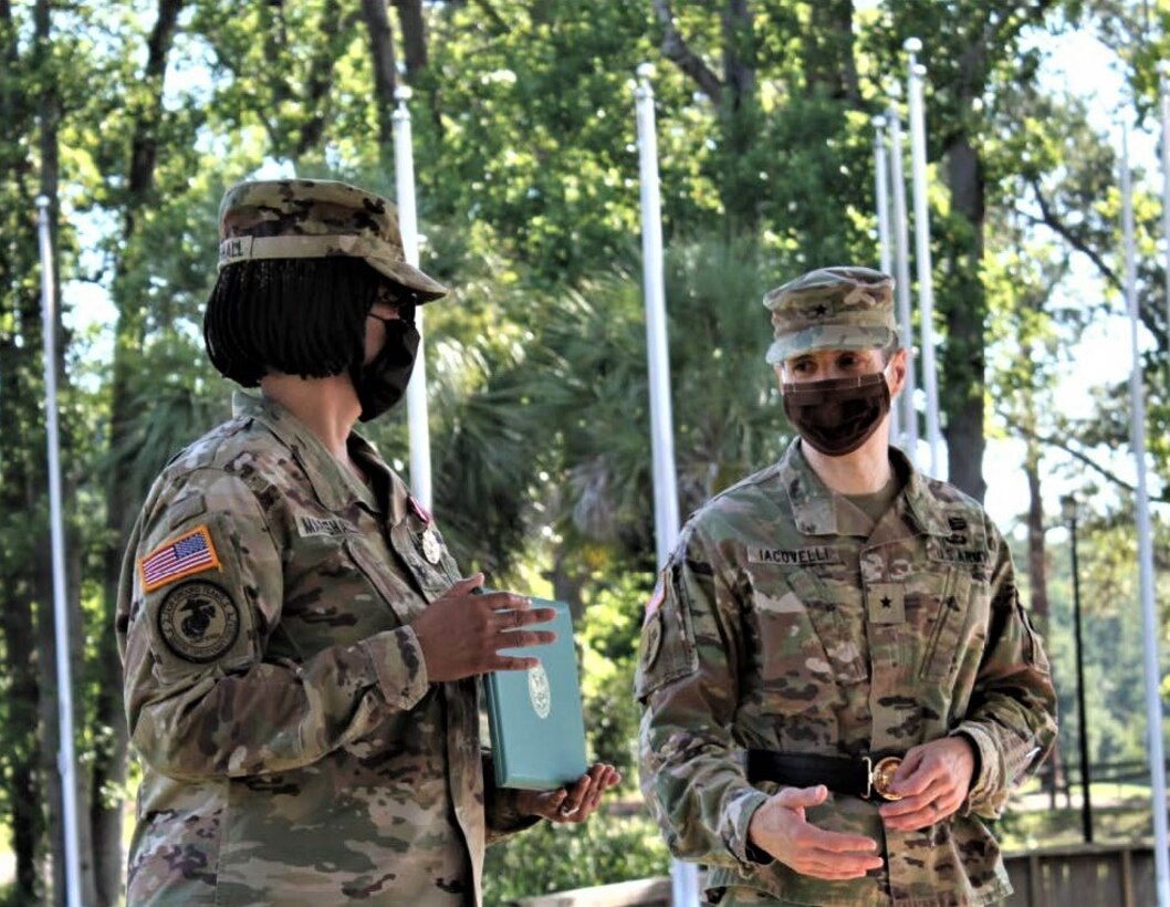 Brig. Gen. Stephen Iacovelli (right), 94th Training Division-Force Sustainment commanding general, gives remarks after presenting Col. Janene Marshall-Gatling, outgoing 4th Brigade (Personnel Services) commander with the Meritorious Service Medal for her commitment to duty and superior performance as the 4th Brigade's commander during the unit’s change of command ceremony. The ceremony was held on Victory Field at Fort Jackson, S.C., July 11, 2020. Marshall-Gatling served as the 4th Brigade (PS) commander for two years before her relinquishment of command to Col. Aaron Wilkes. (U.S. Army Reserve photo courtesy of 1st Lt. Matthew Rutledge, 4th Brigade (PS), 94th TD-FS)