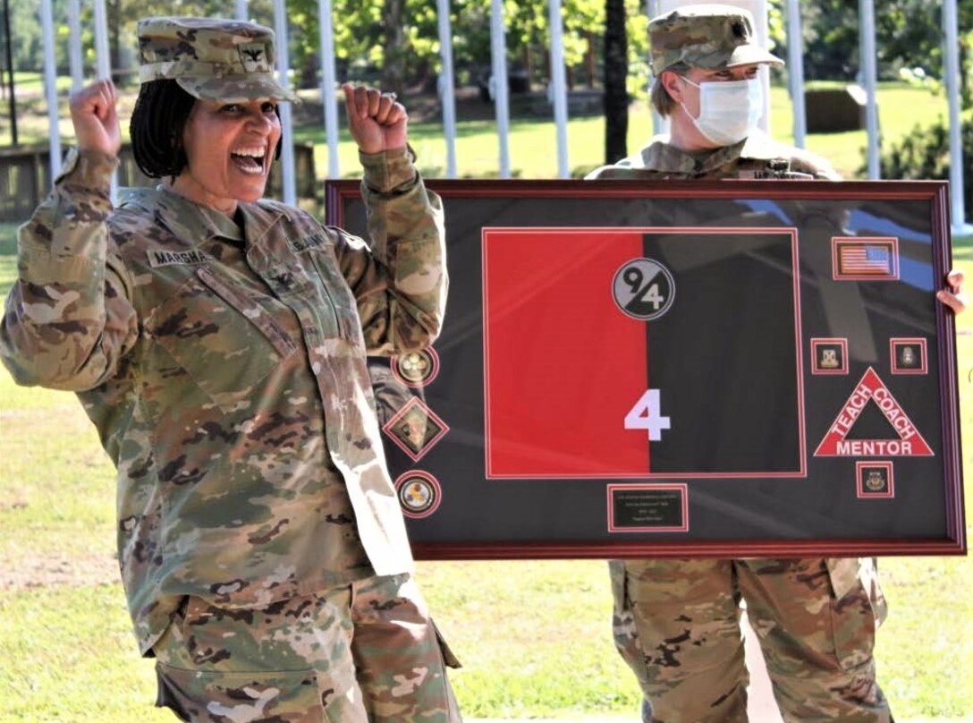 Col. Janene Marshall-Gatling (left), outgoing 4th Brigade (Personnel Services) commander, is all smiles upon receiving a farewell gift from the Soldiers of the 4th Brigade (PS) during the unit’s change of command ceremony. The ceremony was held on Victory Field at Fort Jackson, S.C., July 11, 2020. Marshall-Gatling served as the 4th Brigade (PS) commander for two years prior to her relinquishment of command to Col. Aaron Wilkes. (U.S. Army Reserve photo courtesy of 1st Lt. Matthew Rutledge, 4th Brigade (PS), 94th TD-FS)
