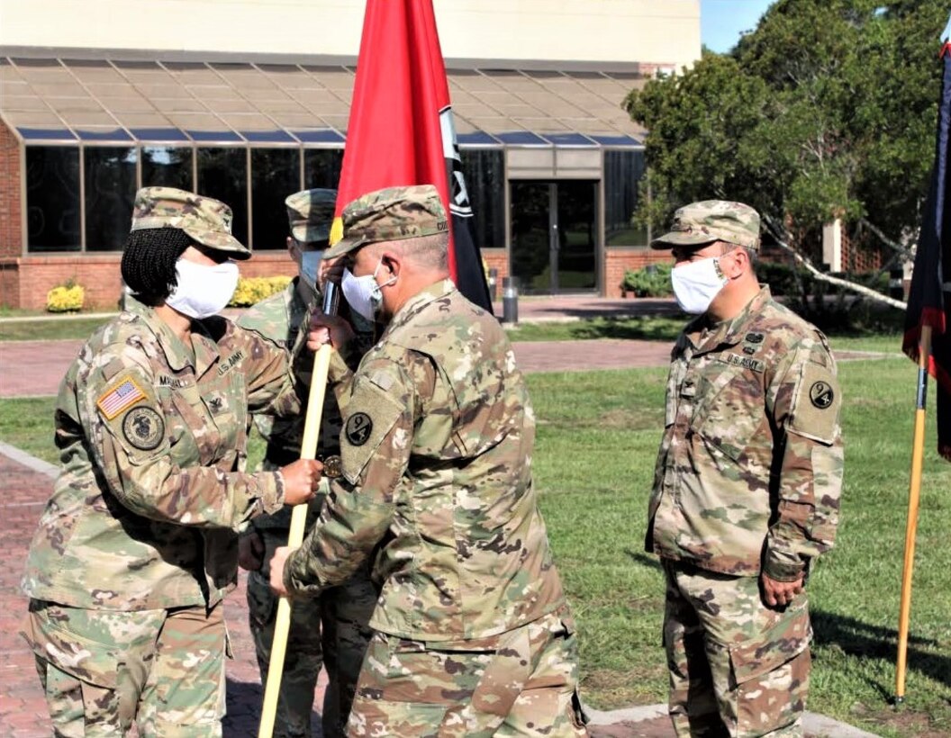 Command Sgt. Maj. Ronald Coots (right), 4th Brigade (Personnel Services) command sergeant major, passes the unit guidon to Col. Janene Marshall-Gatling (left), outgoing 4th Brigade (PS) commander, during the unit’s change of command ceremony held on Victory Field at Fort Jackson, S.C., July 11, 2020. Marshall-Gatling served as the 4th Brigade (PS) commander for two years prior to her relinquishment of command to Col. Aaron Wilkes. (U.S. Army Reserve photo courtesy of 1st Lt. Matthew Rutledge, 4th Brigade (PS), 94th TD-FS)