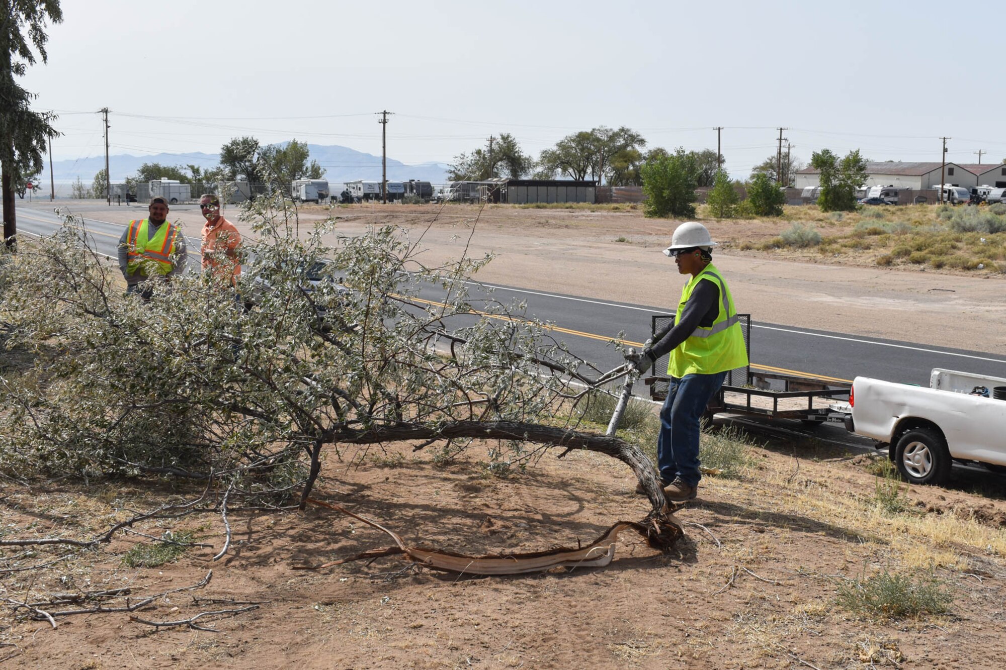 Stanley Hewlen, a base grounds maintenance contractor, drags a tree branch to be shredded.