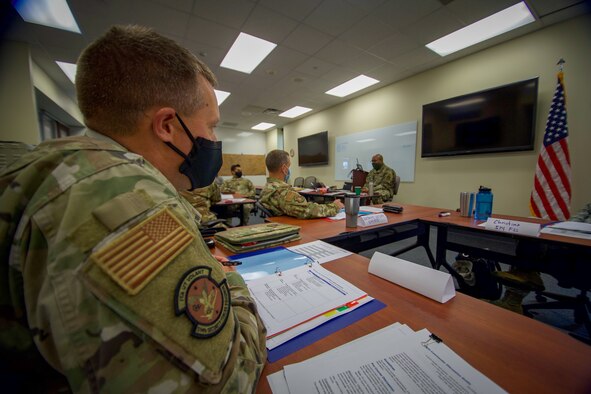 Capt. Steven R. Carroll, Operations Officer, 514th Security Forces Squadron, looks on during the inaugural Flight Commander Leadership Course hosted by the 514th Air Mobility Wing and taught by Lt. Col. Fernando Waldron, Deputy Commander, 514th Mission Support Group.  

During the three day course, the 12 participants learned skills that would allow new flight commanders and similar level leaders to focus on leadership development and application at the unit-level.