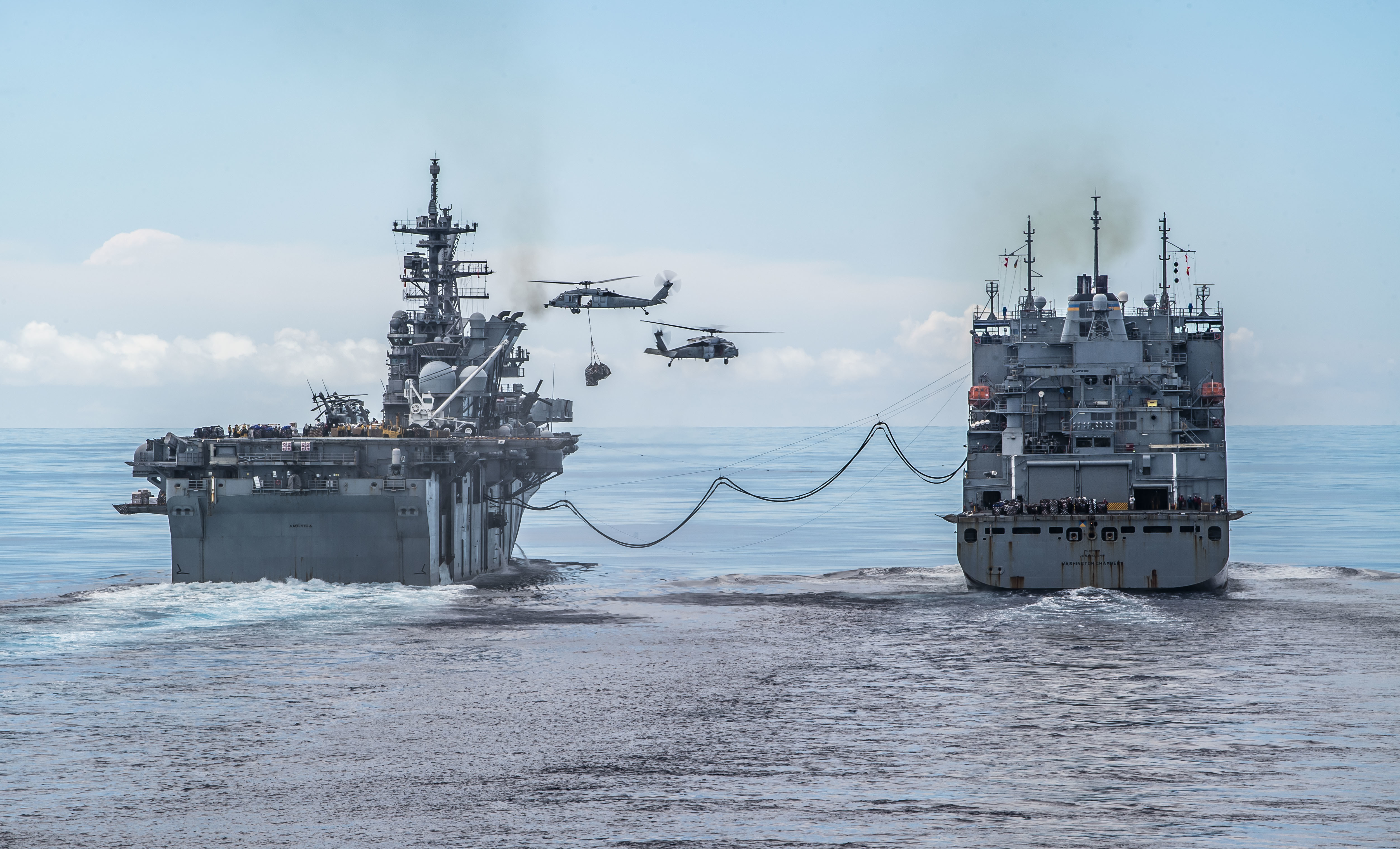 USS America (LHA 6), left, conducts a replenishment-at-sea with USNS Washington Chambers (T-AKE 11).