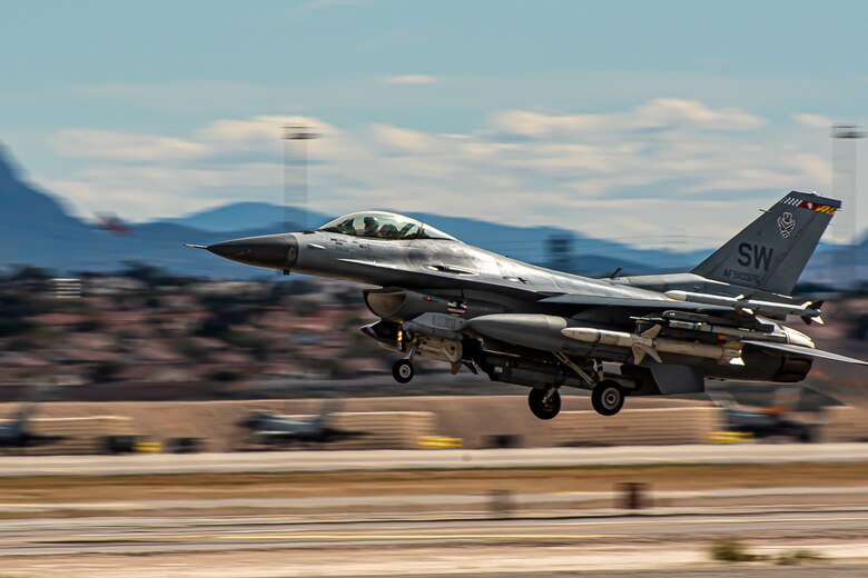 A picture of a jet taking off from a runway.