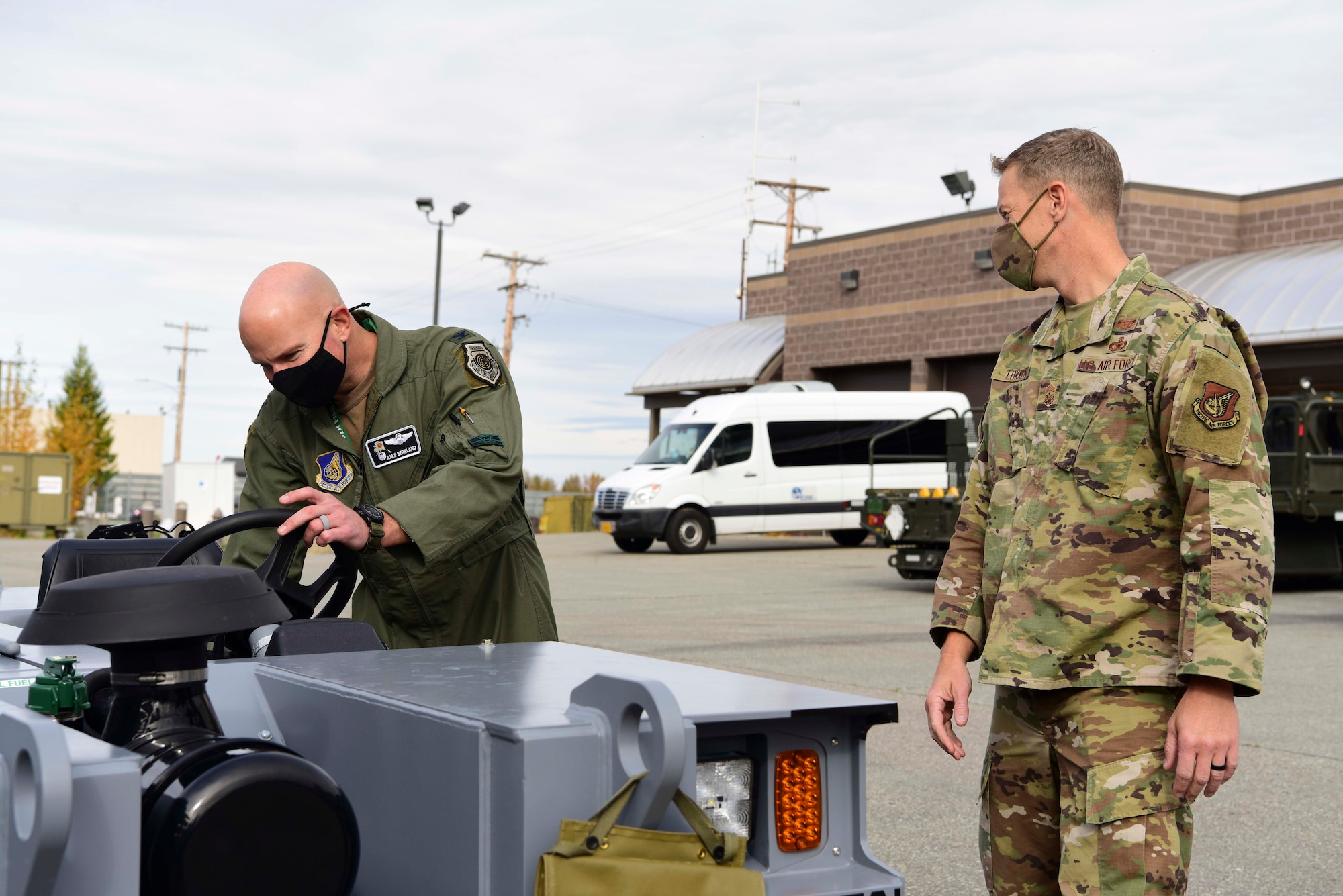 U.S. Air Force Col. David Berkland, the 354th Fighter Wing (FW) commander, and Chief Master Sgt. John Lokken, the 354th FW command chief, examine a vehicle at Eielson Air Force Base, Alaska, Sept. 15, 2020.